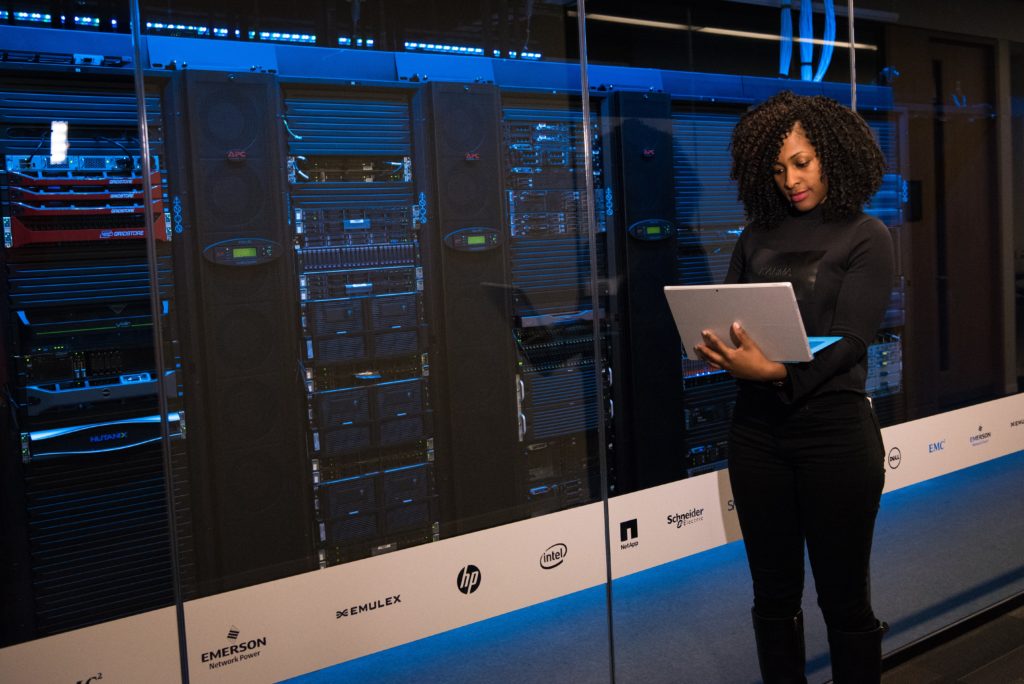 A woman in a server room working on cloud migration
