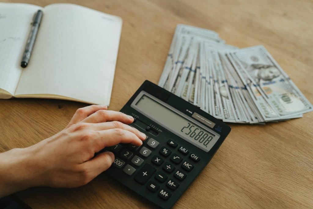 Someone calculating the ROI of managed it services.