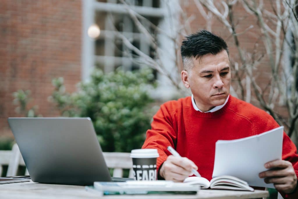 IT manager sitting outside reviewing a KPI report